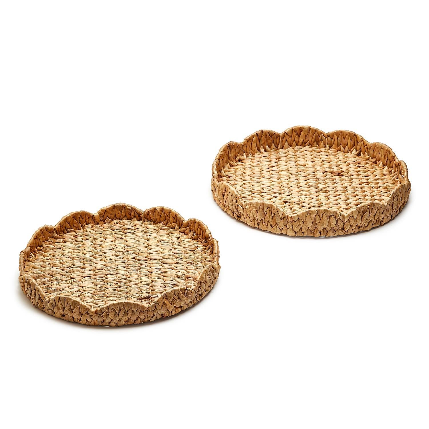 Round scalloped-edge tray made from natural water hyacinth with a light brown woven texture.