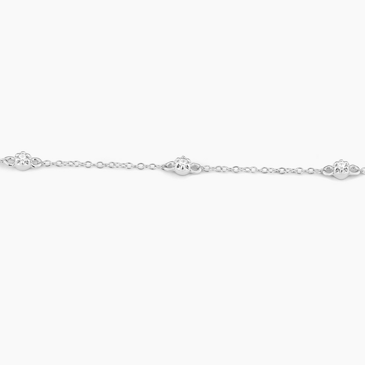 Close-up of the Ara Chain Bracelet in silver with small, round diamond-set charms.
