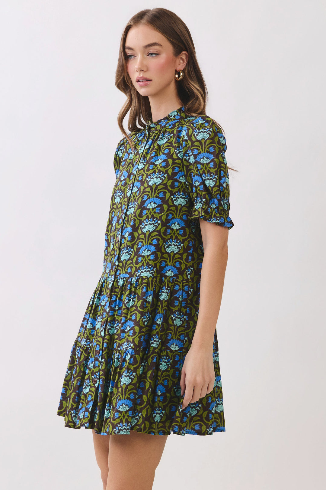Penelope floral print mini dress with puff sleeves, button front, and tiered skirt on a model.