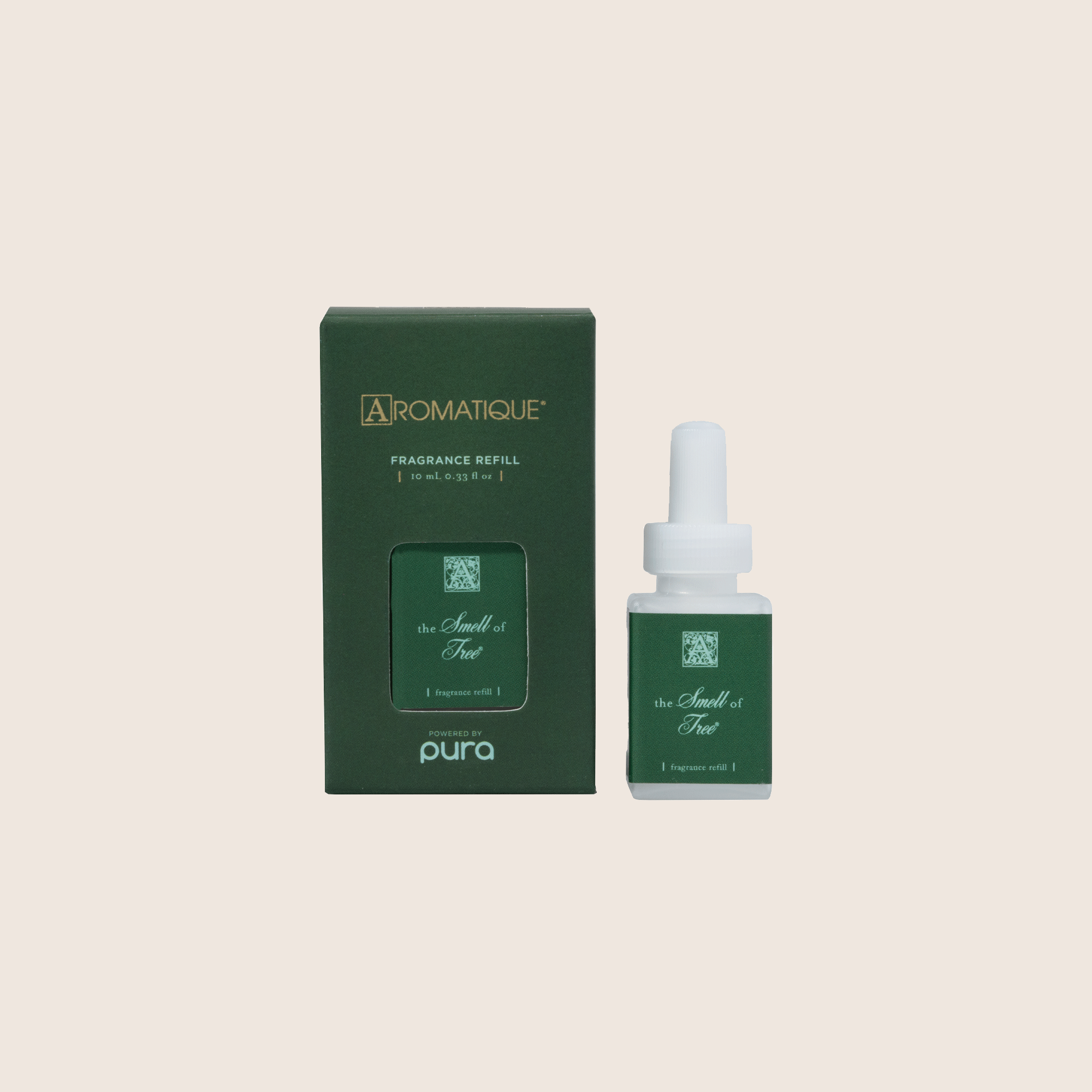 The Smell of Tree Pura fragrance refill bottle next to its dark green Aromatique packaging.