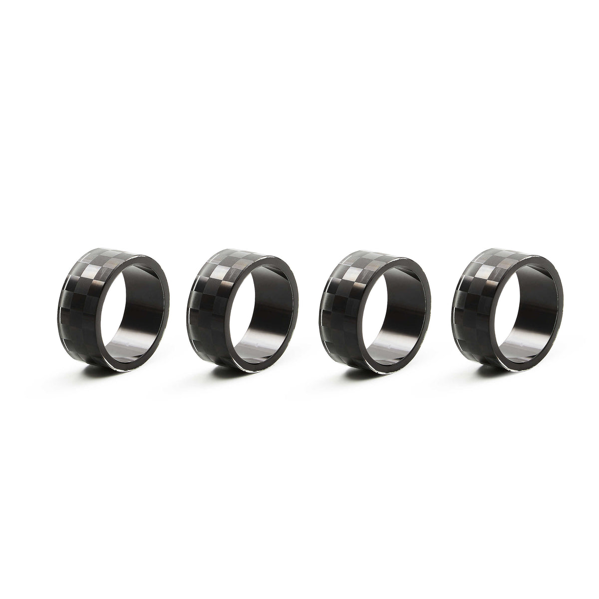 Set of four glass napkin rings with a black and grey checkered pattern.