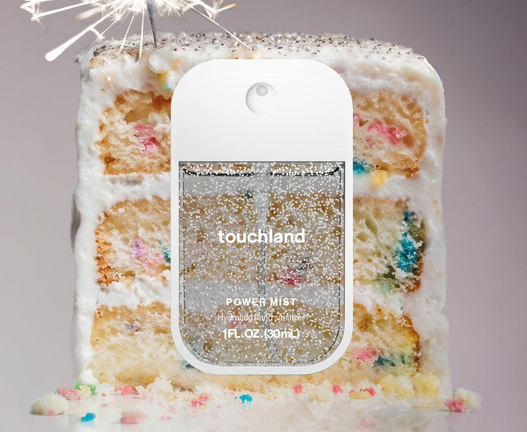 Touchland Confetti Cake Power Mist hand sanitizer in a white bottle with rainbow sprinkles and vanilla bean design.