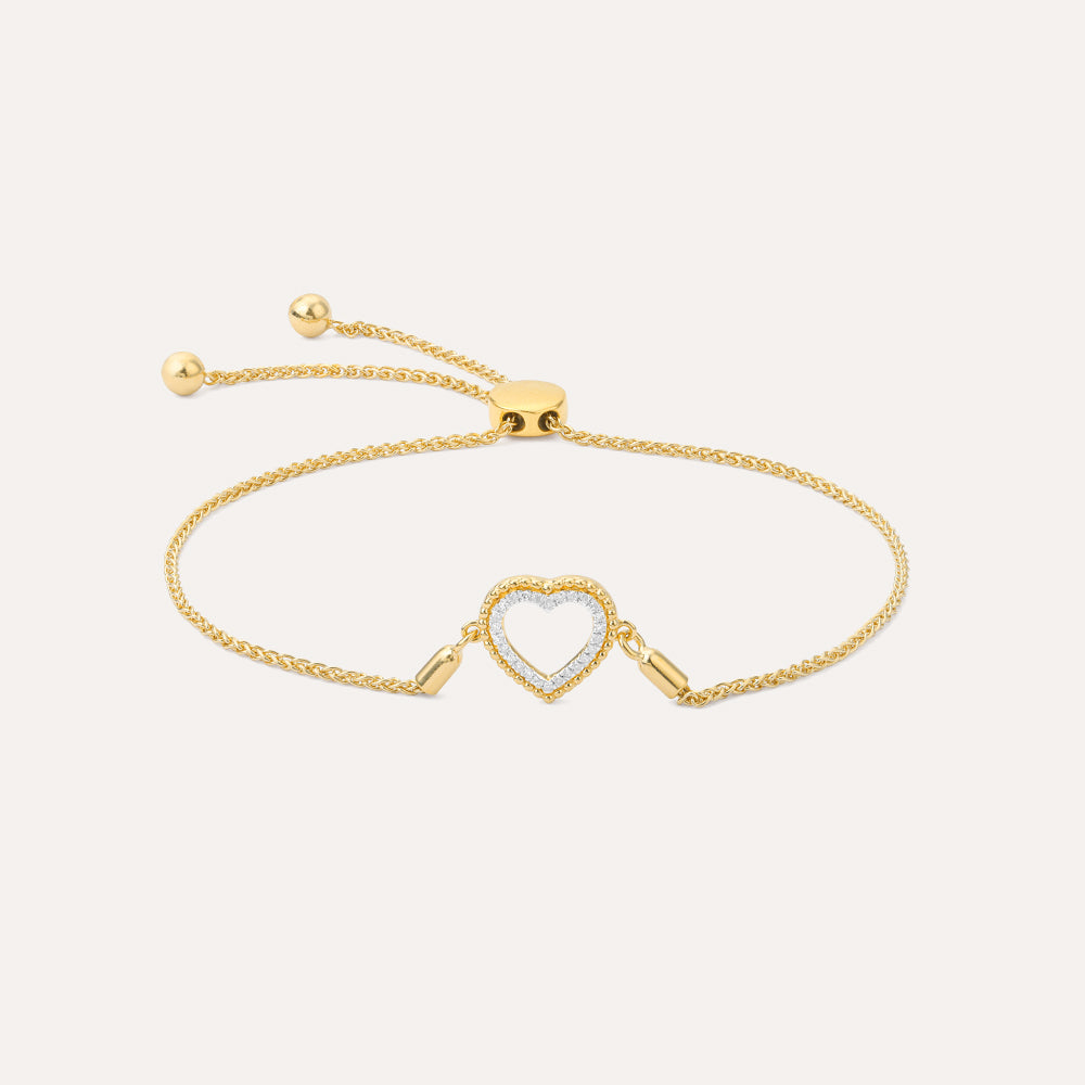 Gold beaded heart bolo bracelet with diamond accents on an adjustable chain.