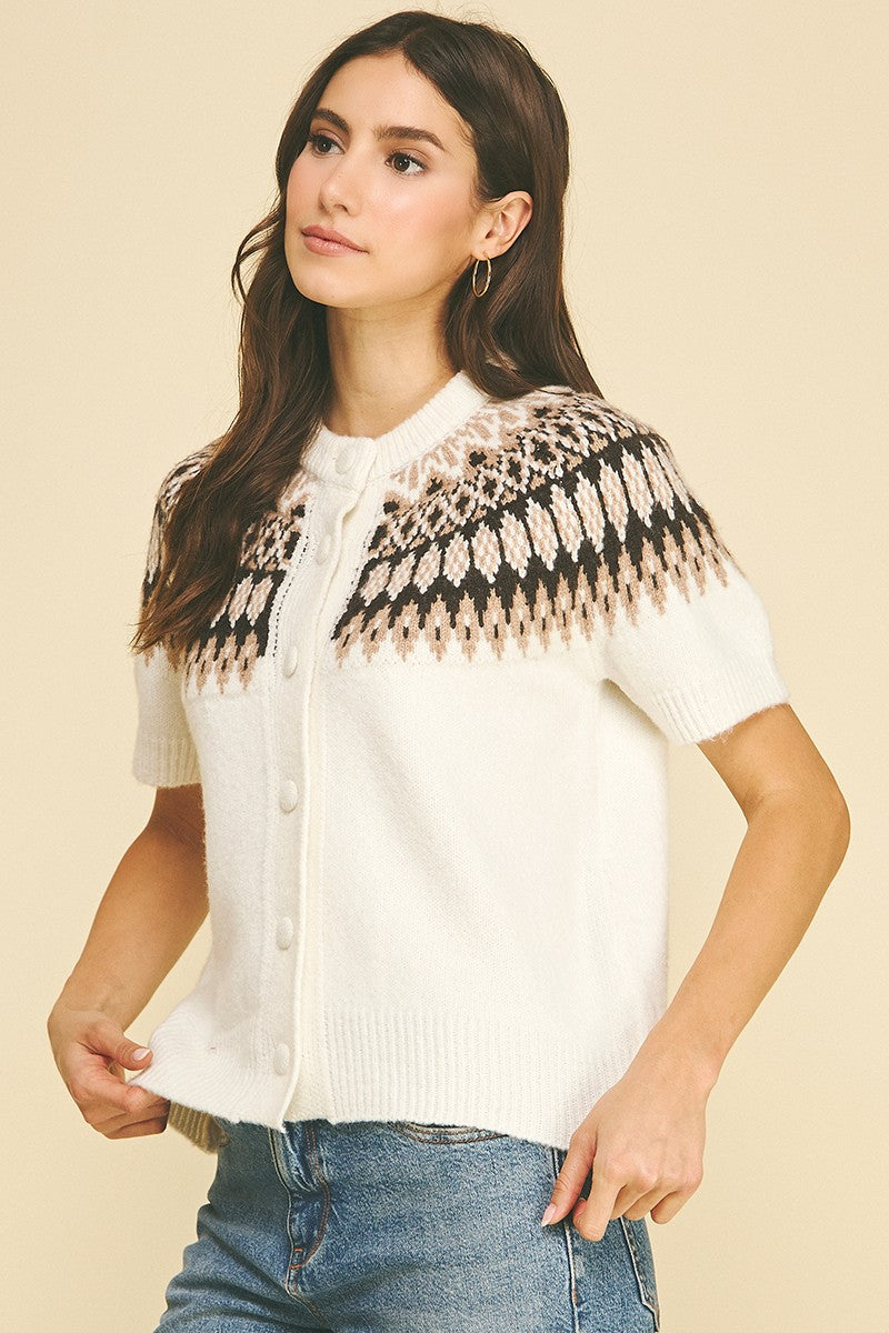 Woman wearing the Jessica Nordic short sleeve knit cardigan in white with a brown fair isle pattern.