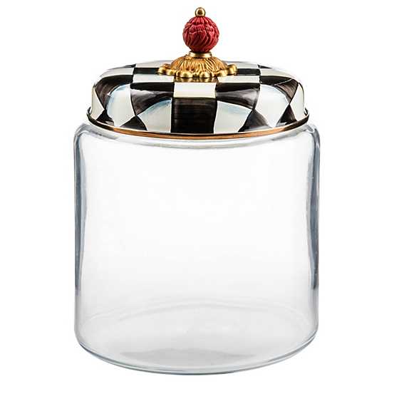 Large glass kitchen canister with a black and white checkered enamel lid and a red finial.