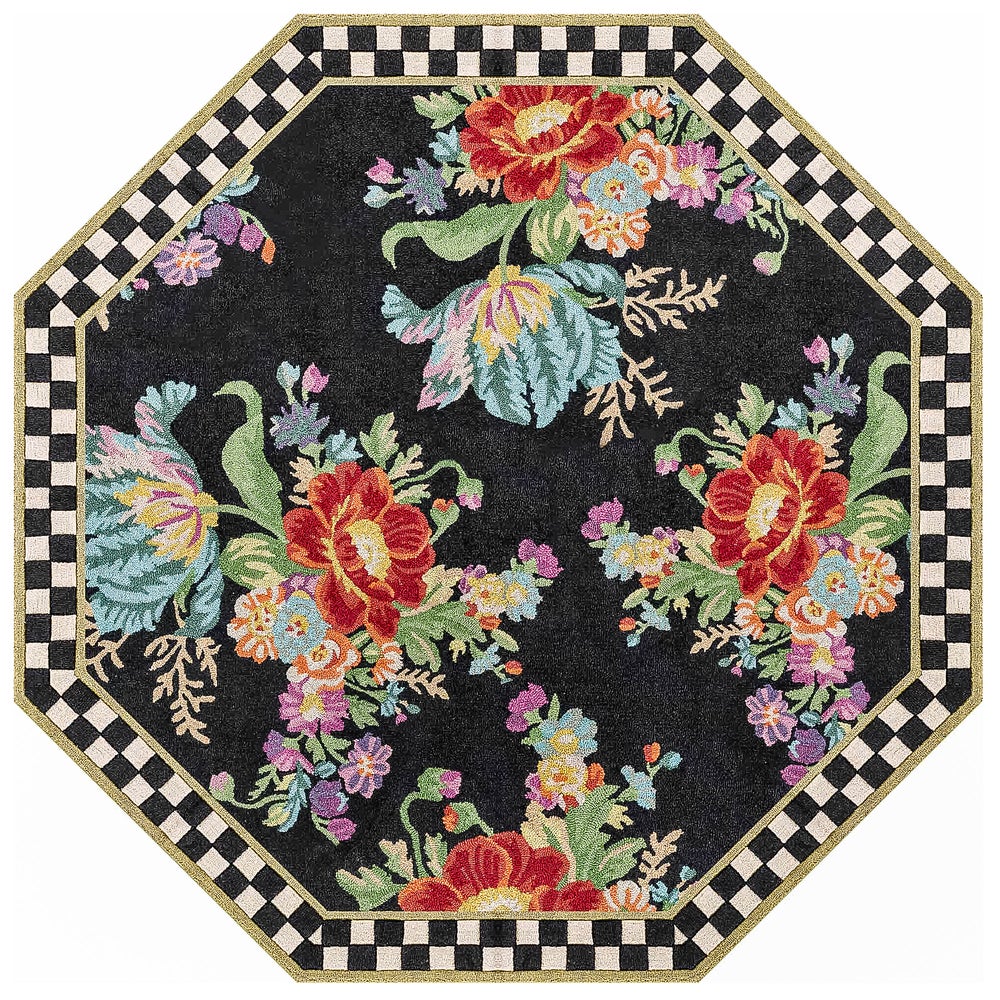 Octagonal black rug with colorful floral bouquets and a black and white checkered border.