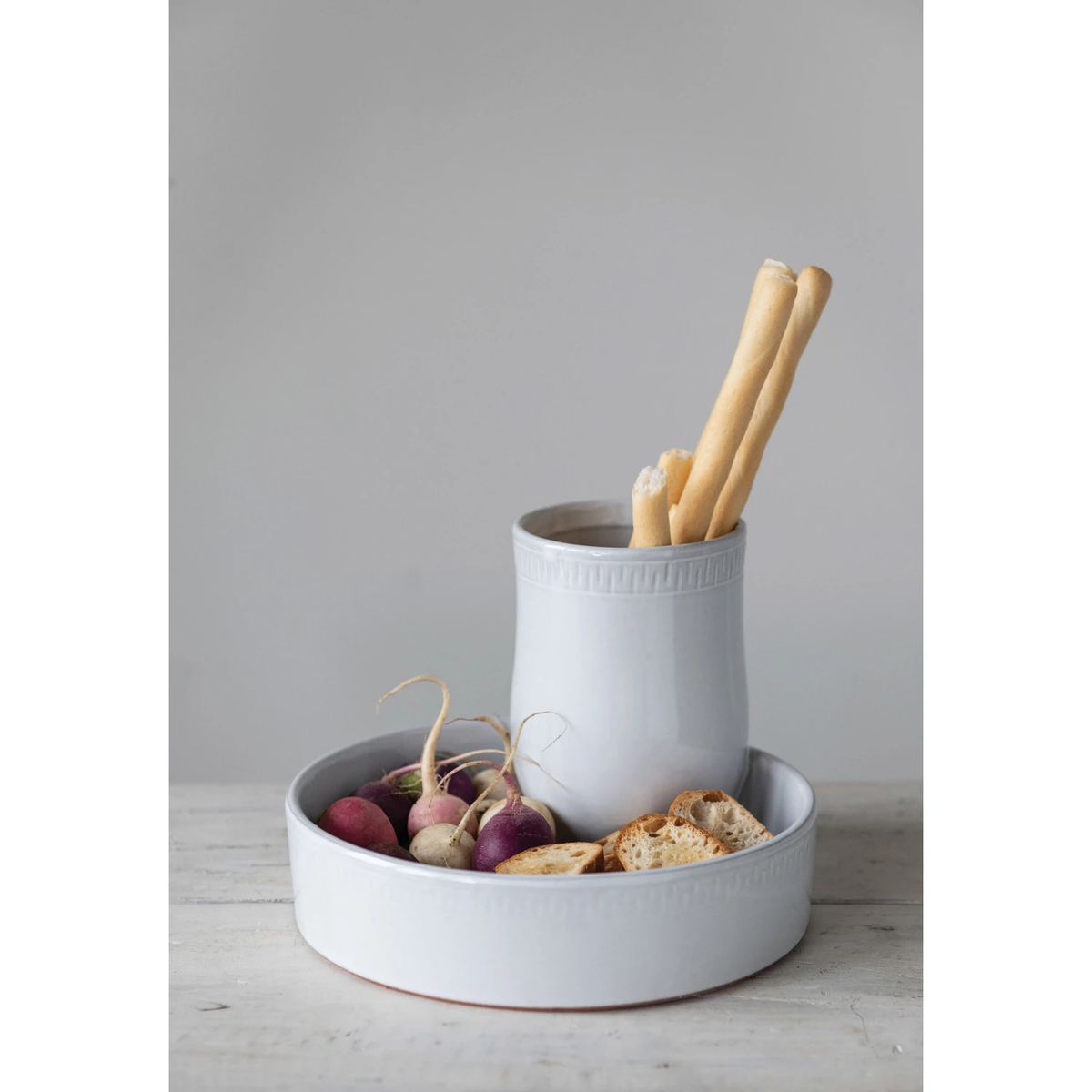Terracotta round tray with two compartments featuring a reactive glaze finish