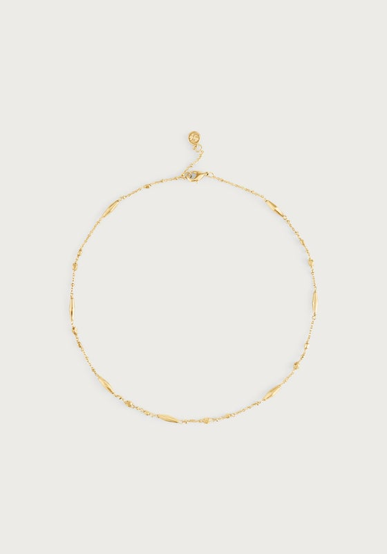 Milos Multi Beaded Necklace in gold featuring a delicate chain with elongated and round beads.