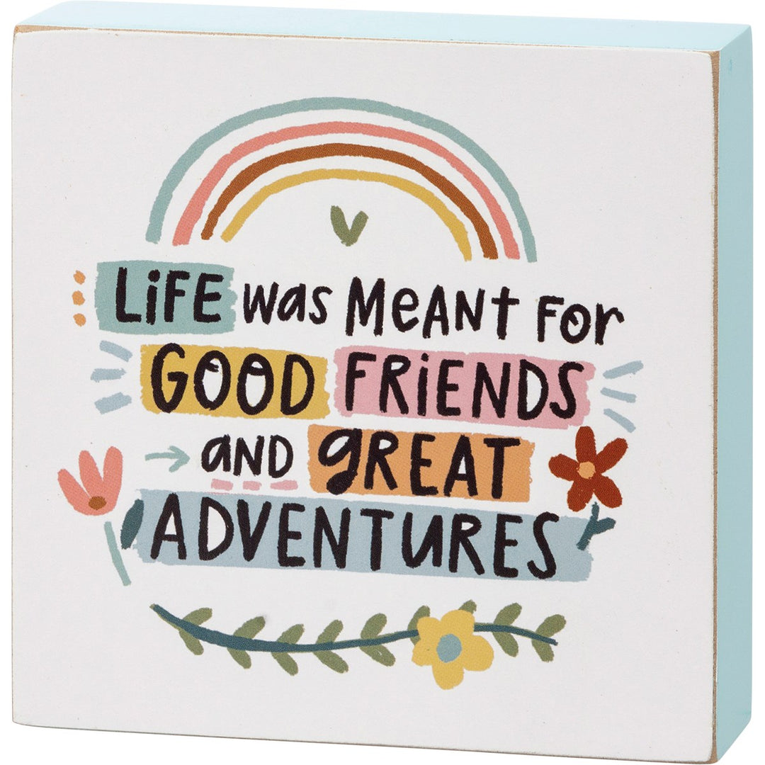 Wooden box sign with a rainbow and text: Life was meant for good friends and great adventures.