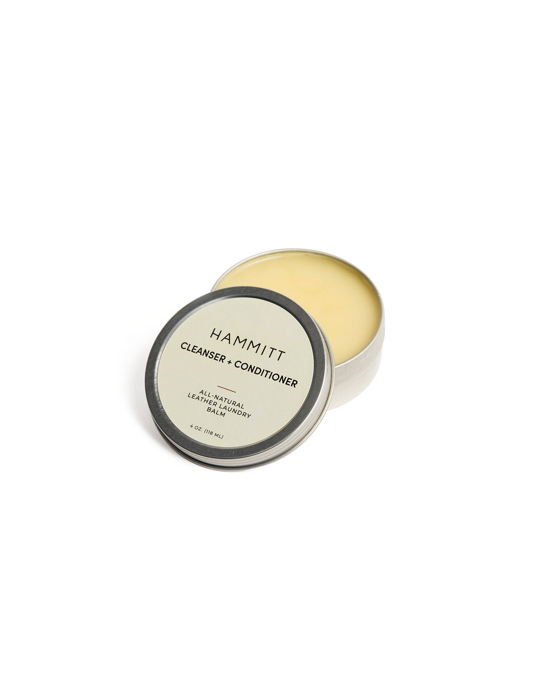 Hammitt Leather Conditioning Balm in a 4 oz. metal tin with the lid leaning against it.