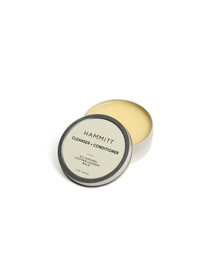 Hammitt Leather Conditioning Balm in a 4 oz. metal tin with the lid leaning against it.