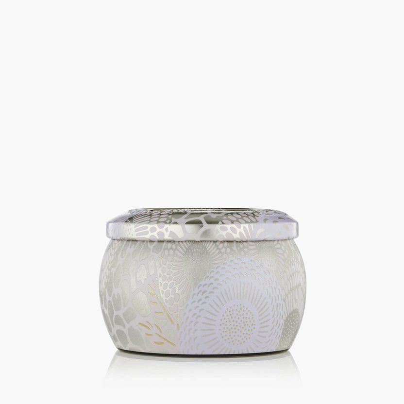 Santal Vanille Mini Tin candle in a small rectangular metal tin with a visible wick and melted wax pool.