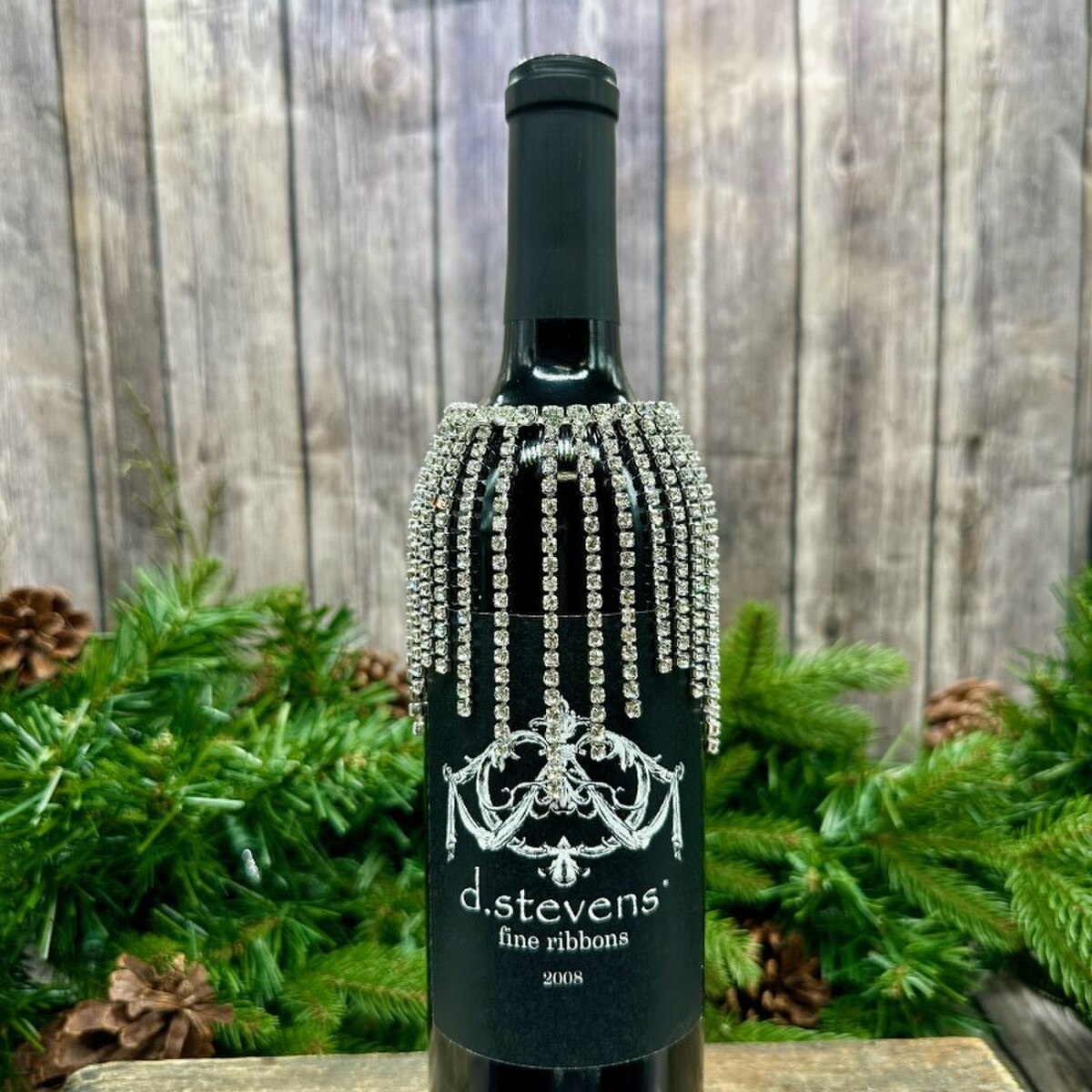 3.5-inch clear crystal jewel fringe wine collar on a dark wine bottle with a black label.
