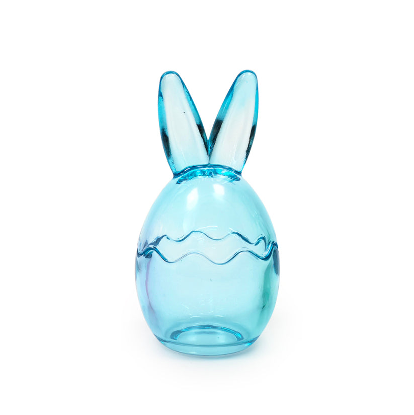 Blue glass Easter egg with bunny ears and wavy line detail.
