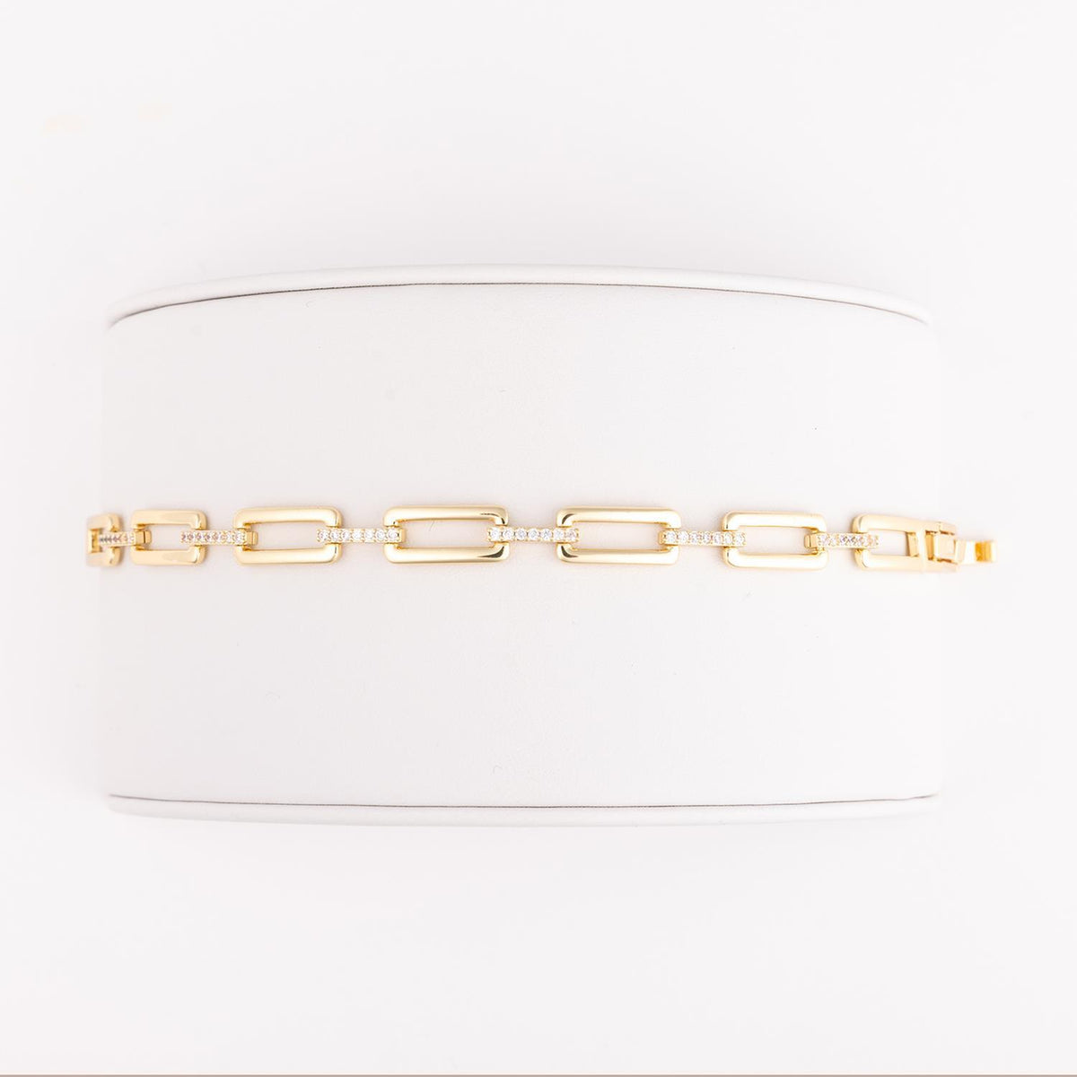 Marley bracelet: rectangular link chain in gold with clear CZ stone accents.
