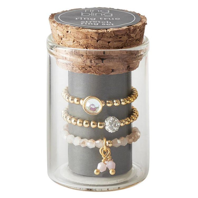 Brass stretch ring set with glass jars in a cork-lined box