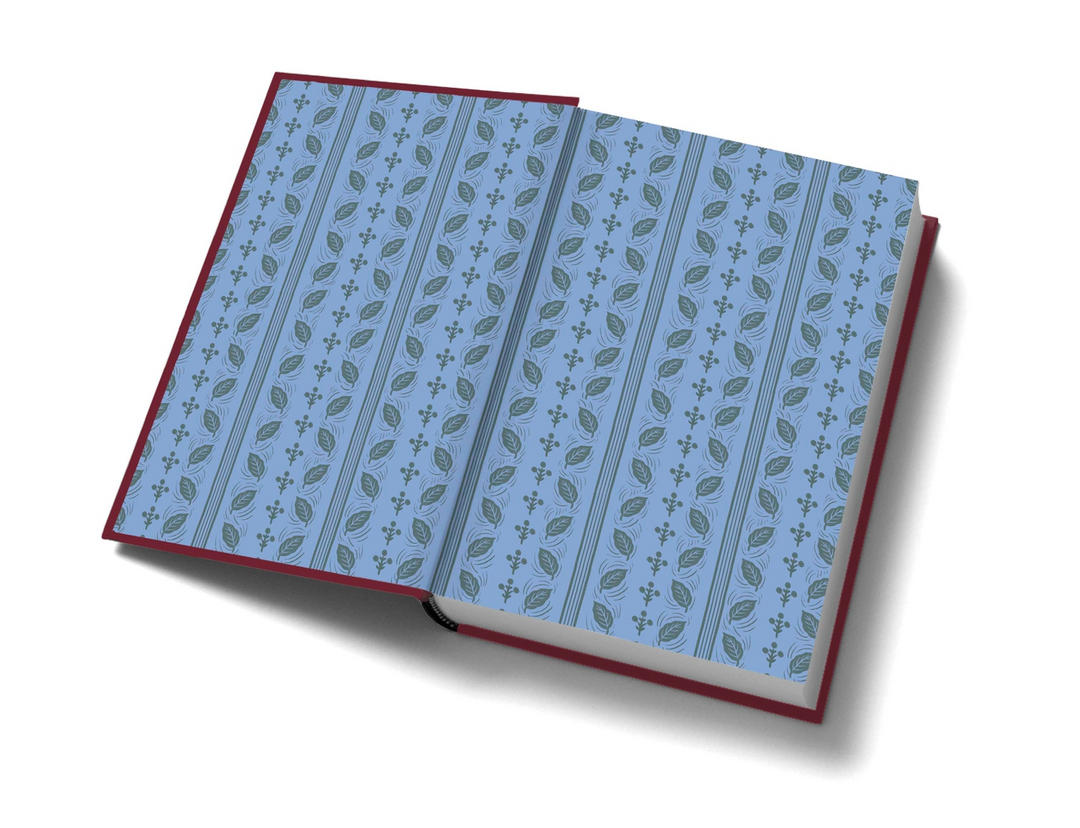 Open copy of Wuthering Heights showing blue endpapers with a repeating leaf and floral pattern.