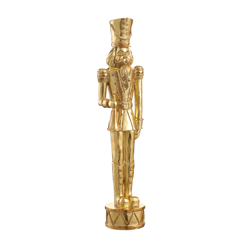 Gold resin nutcracker figurine standing on a drum base.