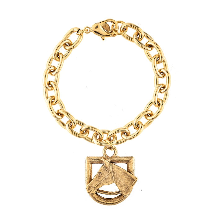 Gold link chain bracelet with a sculpted horse head motif charm in an antique finish.