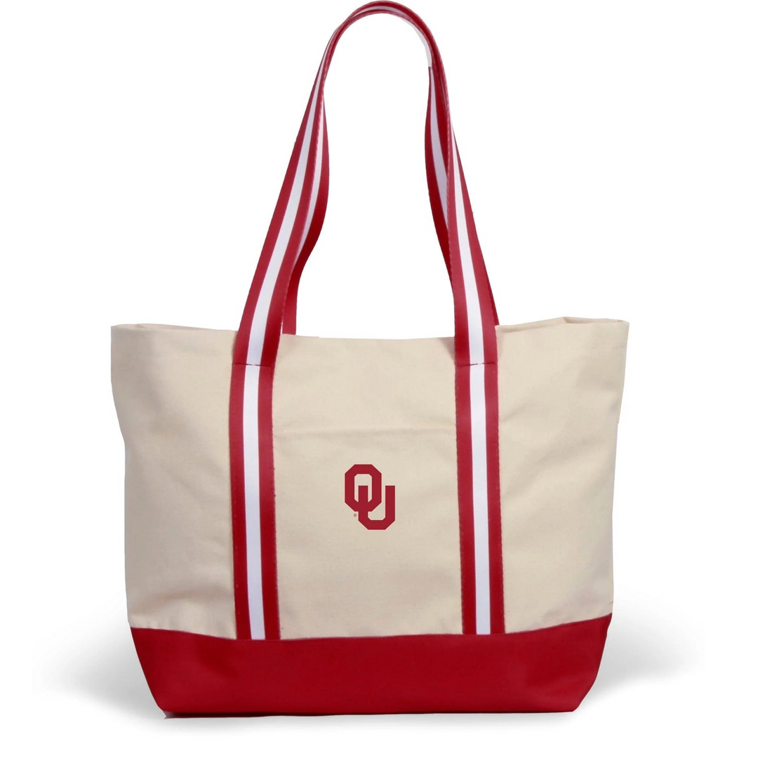 Cream canvas tote bag with red base, striped handles, and red Oklahoma OU logo on the front.