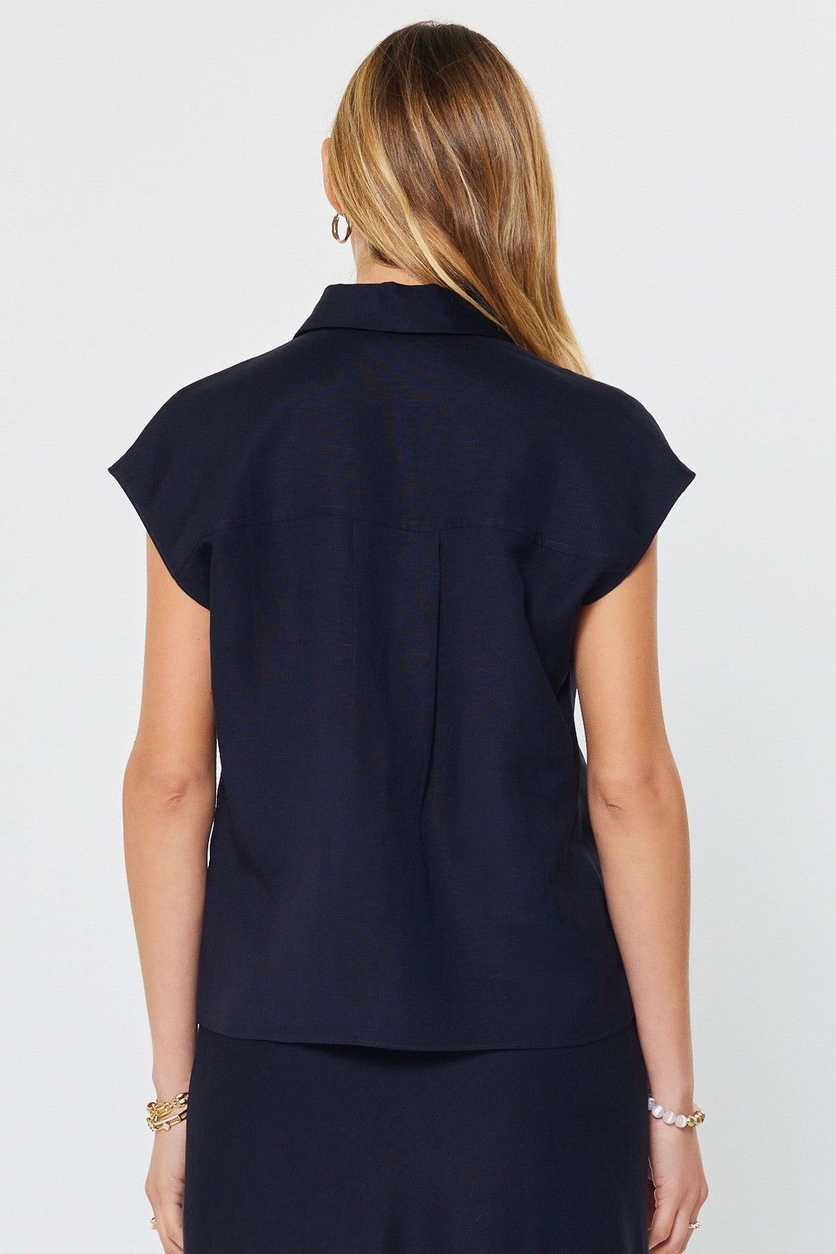Madison cap-sleeve button-down blouse in light beige linen-rayon blend with a relaxed silhouette and front buttons.