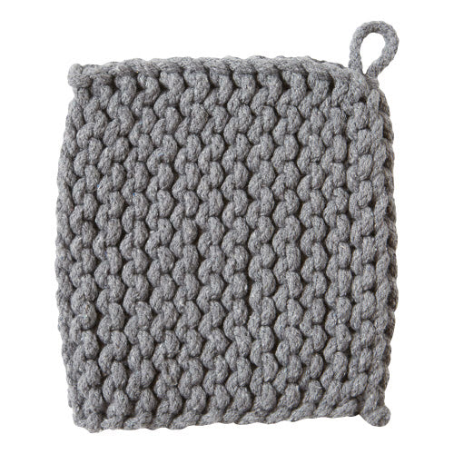 Hand-crocheted cotton trivet in natural beige with a textured circular silhouette.
