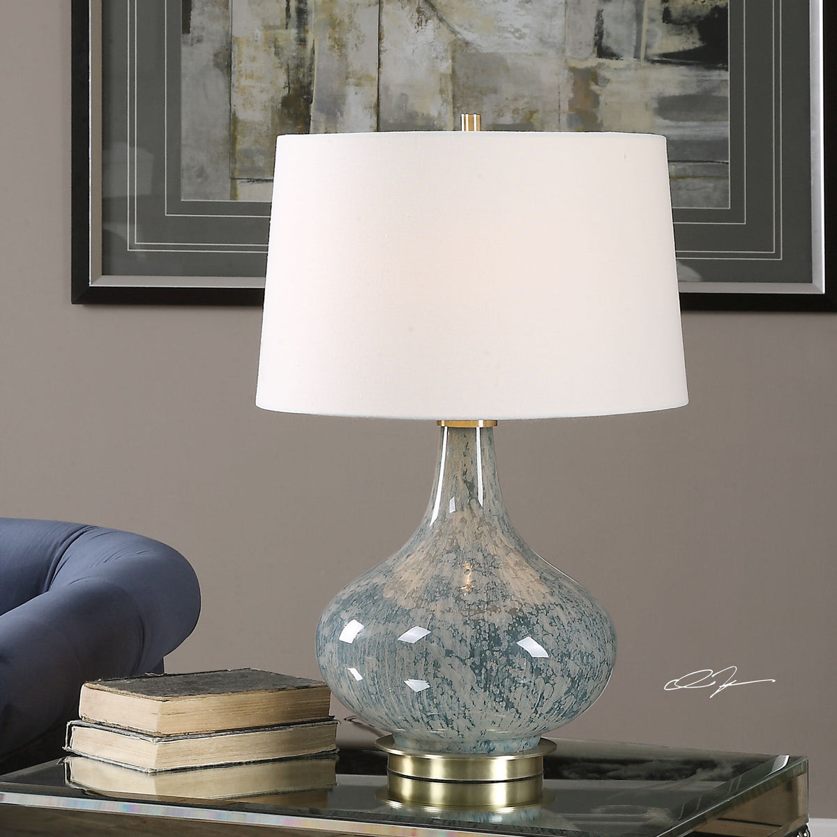 Celinda blue gray glass table lamp with a curved silhouette