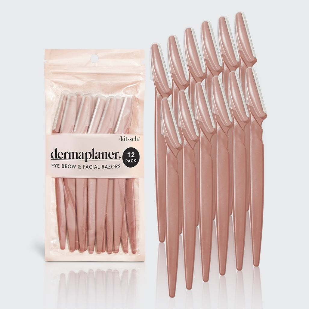 Blush-colored eco-friendly dermaplaner tool with a rounded handle.