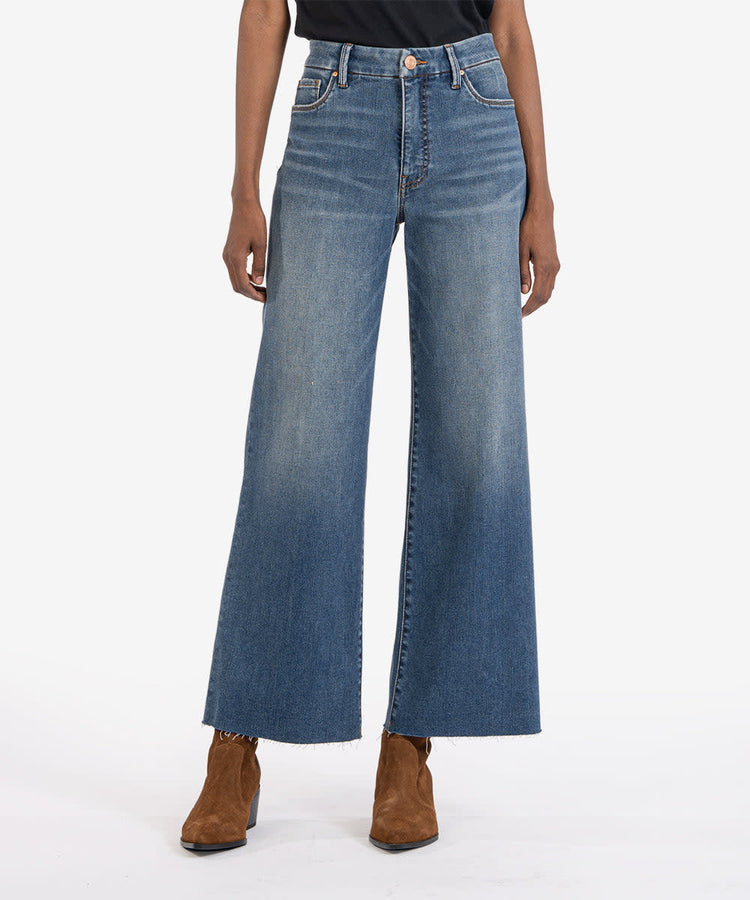 Meg High Rise Fab Ab wide leg jeans in a medium wash with a raw hem and brown suede boots.