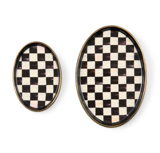Set of two oval ceramic trinket trays with a black and white checkered pattern and gold luster rim.