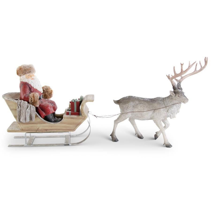 13.5 inch resin figurine of Santa in a fur-trimmed suit sitting in a sled pulled by a reindeer.