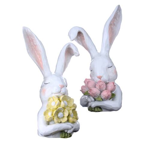 Resin bunny figurine holding pink flowers with a thoughtful expression