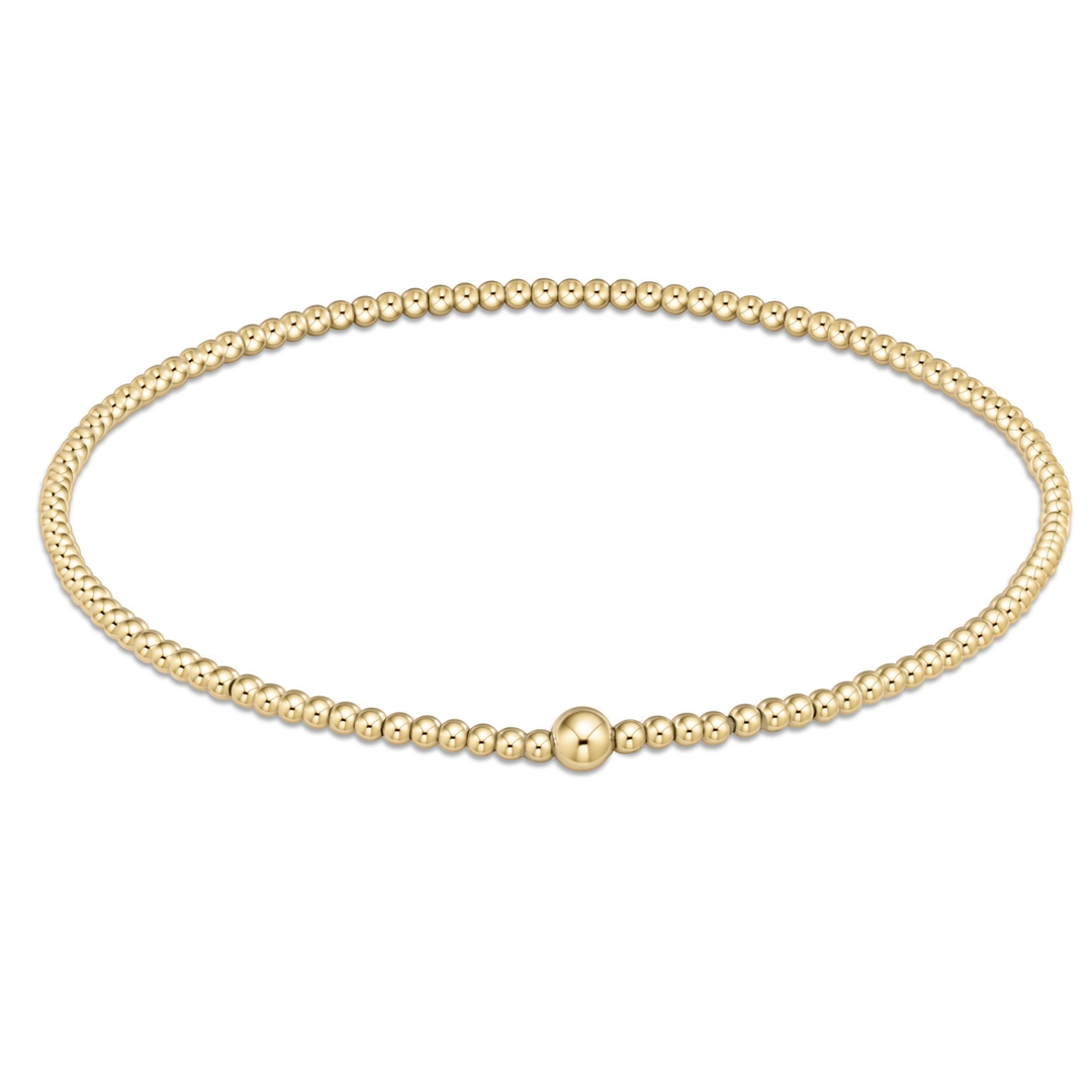 Classic Gold 2mm Bead Bangle featuring a single larger gold bead accent.