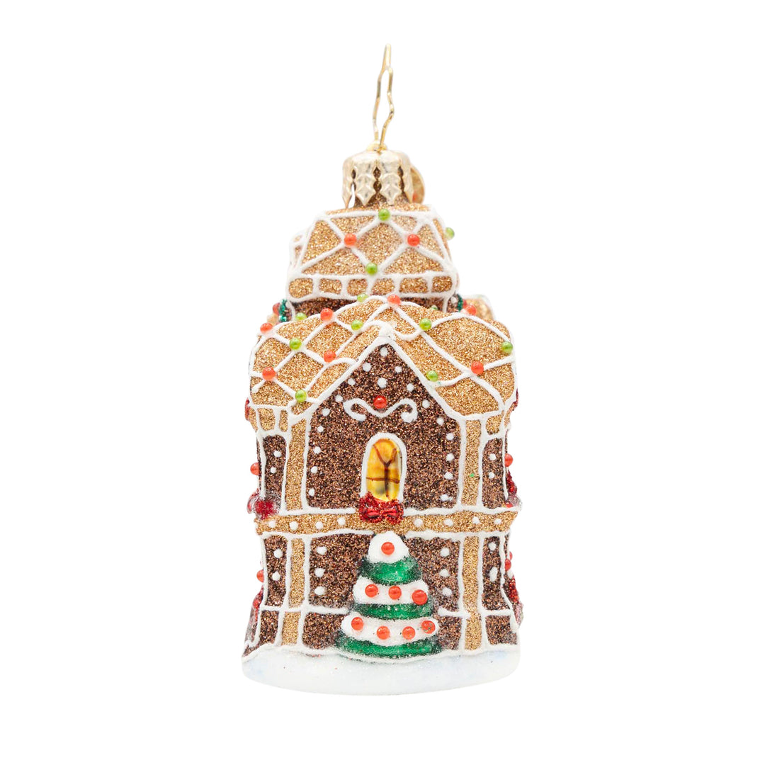 Gingerbread Manor Gem glass ornament with glitter frosting, candy accents, and a Christmas tree.