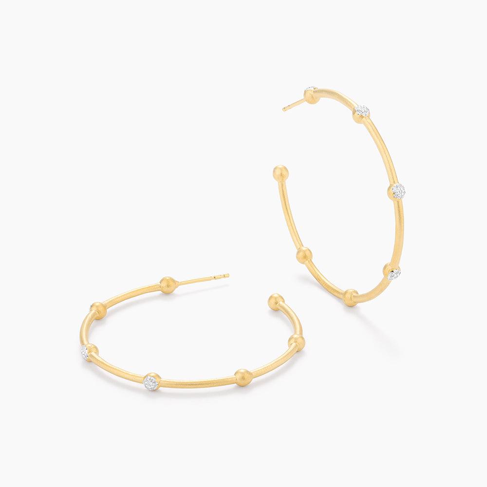 Evelyn medium hoop earrings with genuine diamond accents in a sleek silver finish.