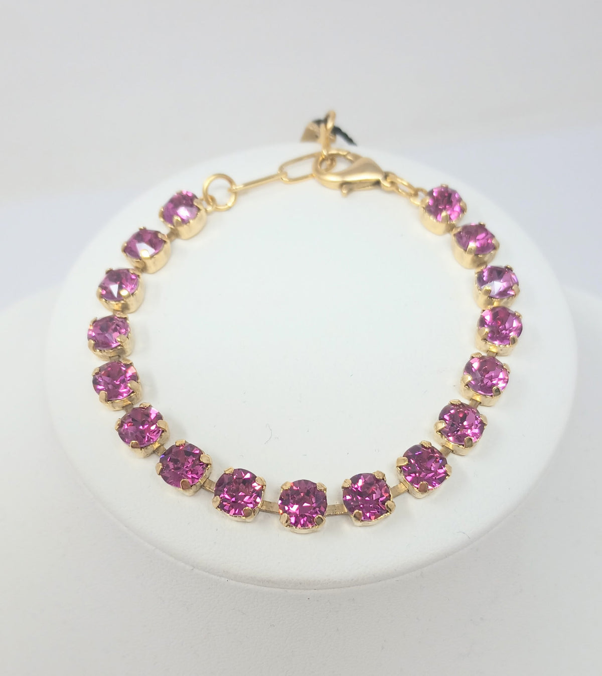 Sarina Bracelet featuring pink round crystals in antique gold-plated settings with a lobster clasp.