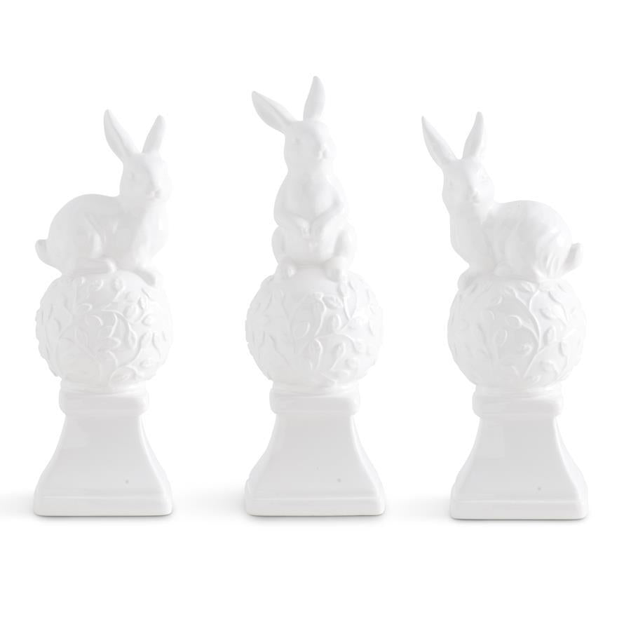 White ceramic finial shaped like bunnies on top with a graduated silhouette
