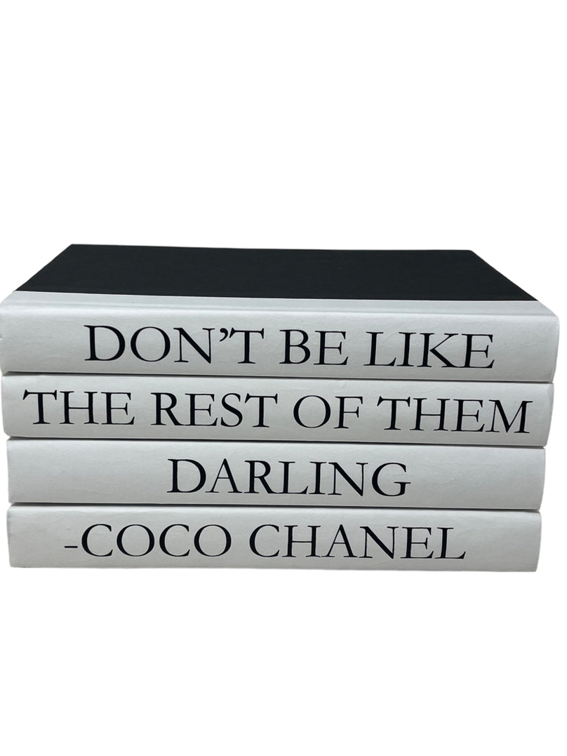 Set of 4 black and white books with a Coco Chanel quote on the spines.