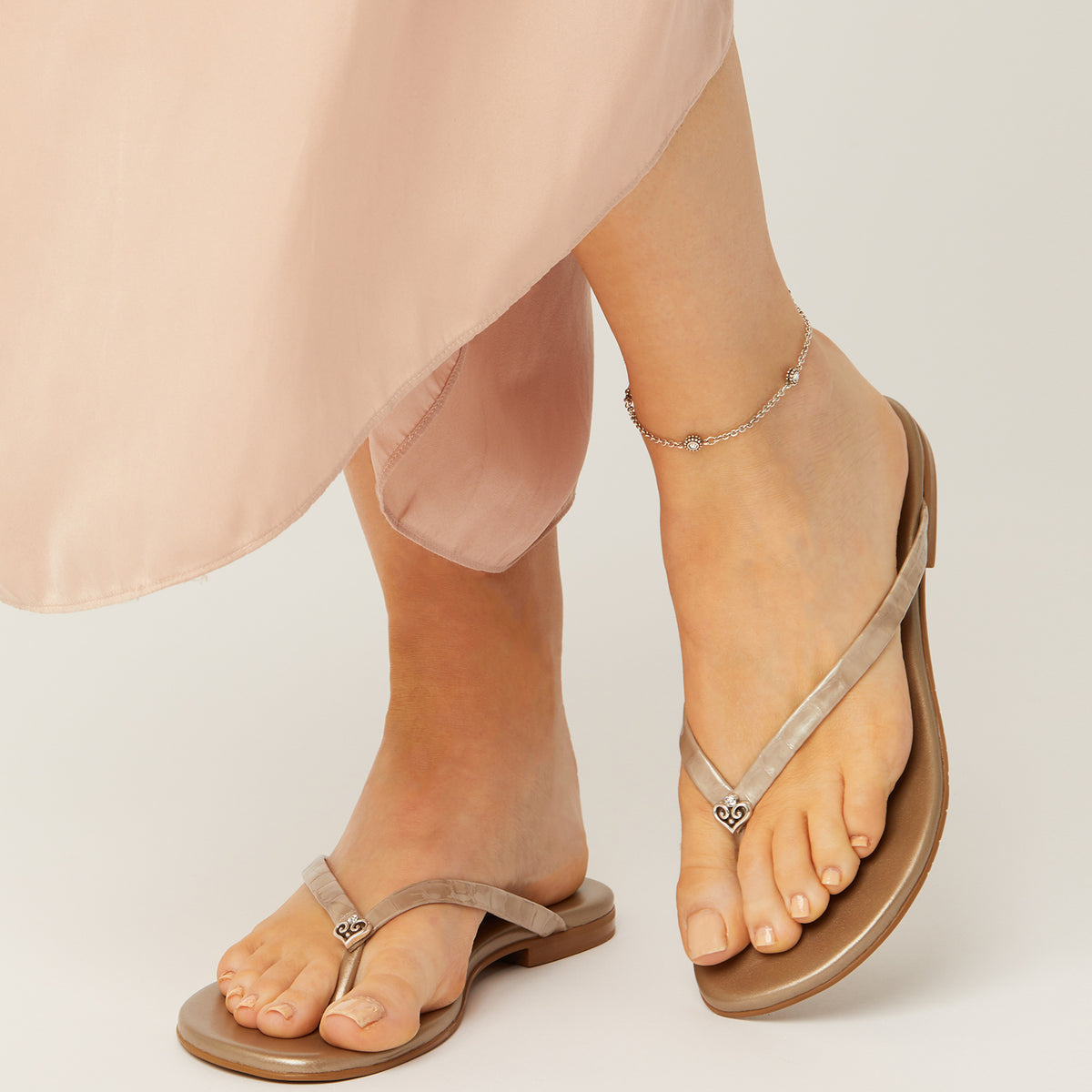 A person wearing the Twinkle Crystal Anklet in silver with a lobster claw closure.