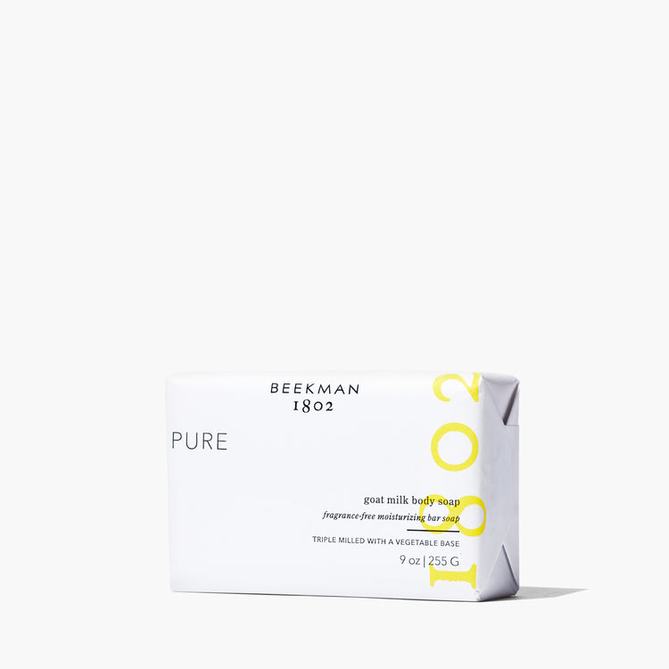 Triple-milled bar soap with a creamy off-white color featuring embedded specks of goat milk.