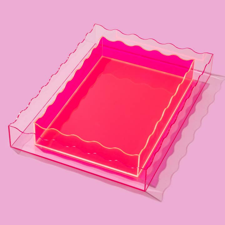 Large neon pink acrylic wavy rectangle tray nested inside a larger clear wavy tray.