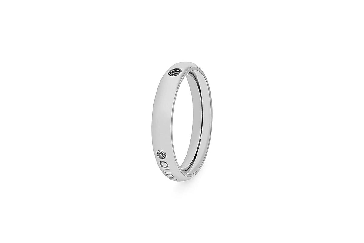 Silver ring with a small screw hole on the top and engraved flower and text on the side.