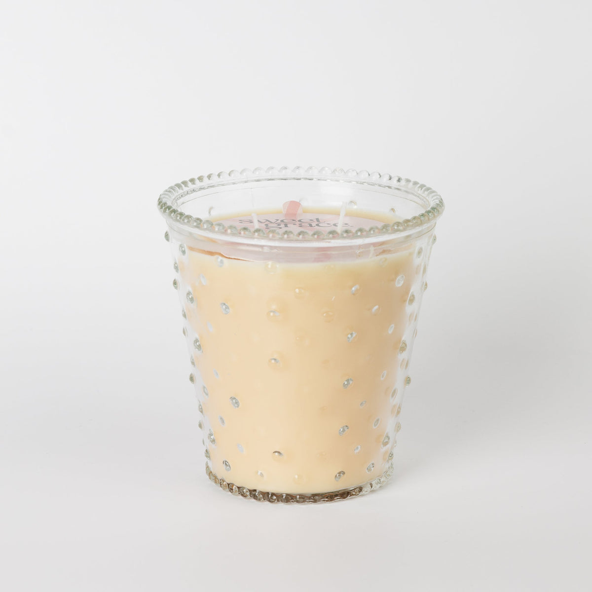Sweet Grace Collection Candle #080 in a clear hobnail glass vessel with cream-colored wax.