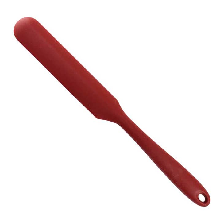 Red silicone icing spatula with a long, thin blade and a tapered handle with a hanging hole.