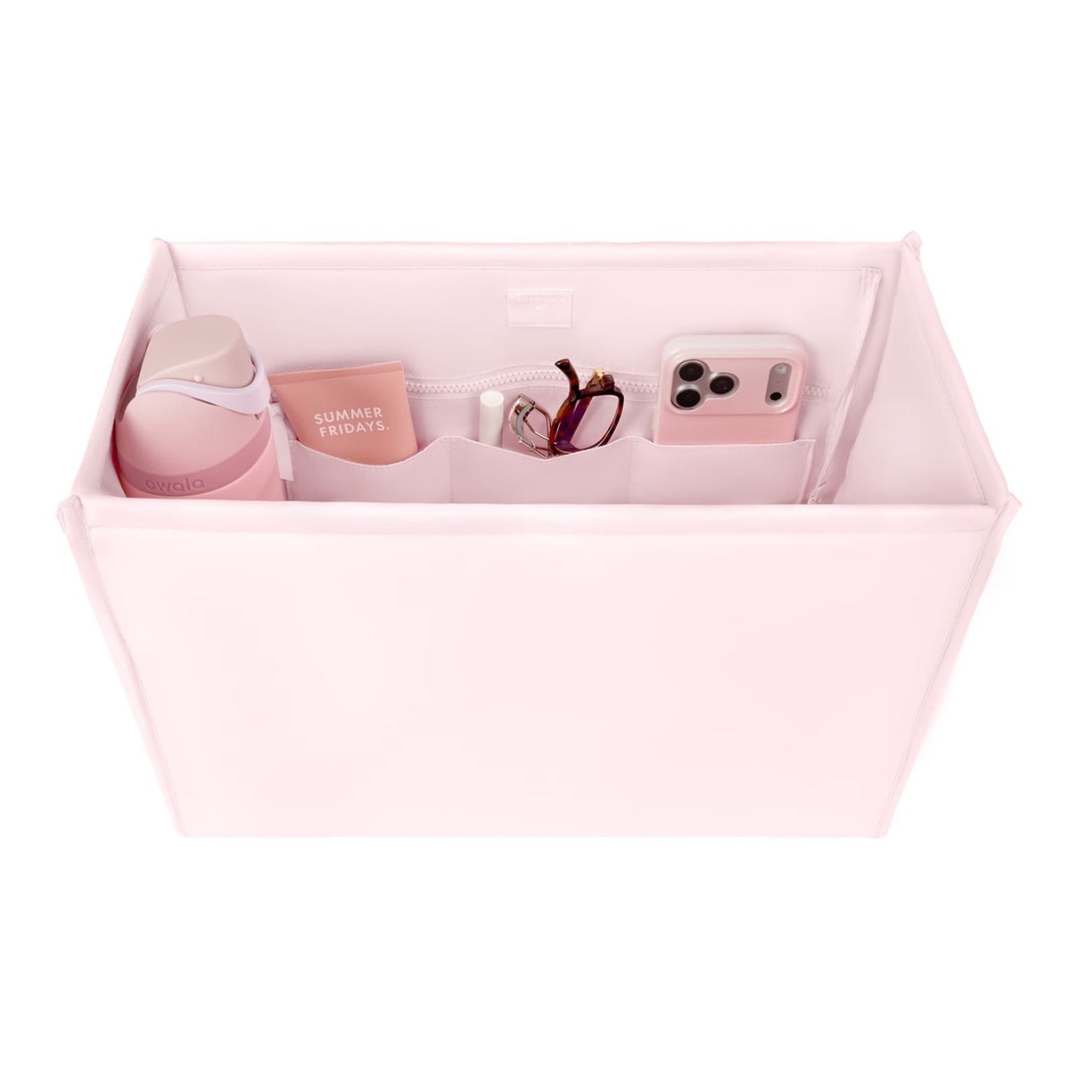 Pink structured tote organizer insert with compartments holding a water bottle, phone, and makeup.