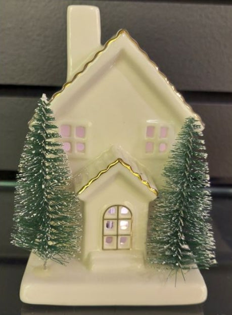 Translucent white porcelain house with gold trim, a chimney, and two green bottle brush trees.