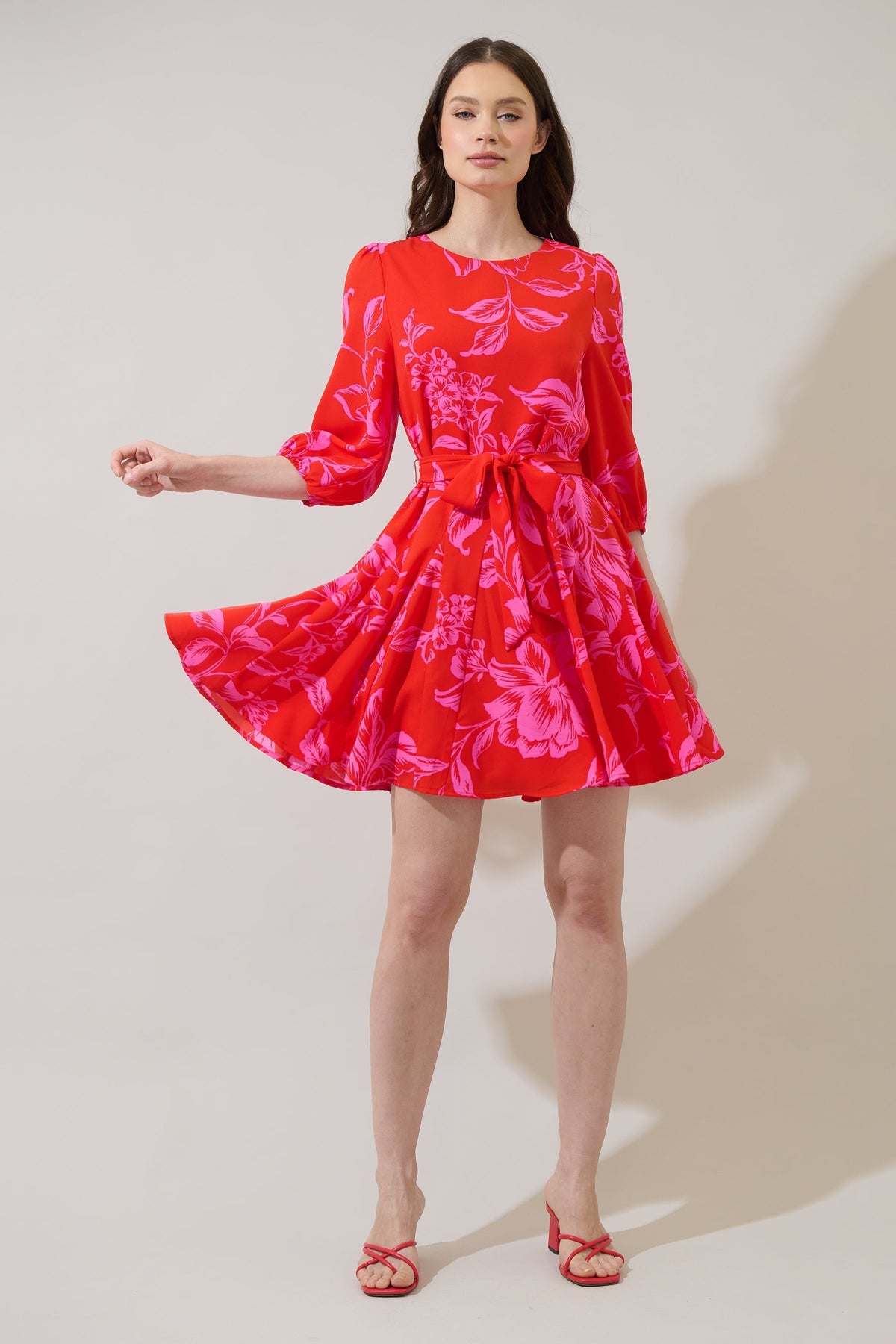 Floral print mini dress with balloon sleeves, fit-and-flare godet silhouette, and tie waist belt.