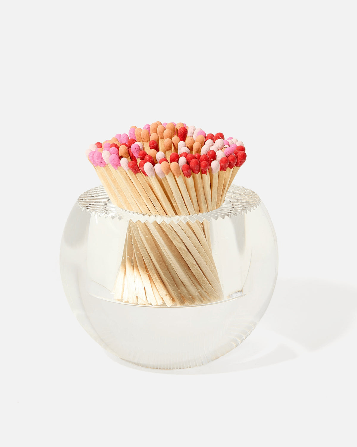 Round clear glass match striker filled with pink, red, and tan matches.