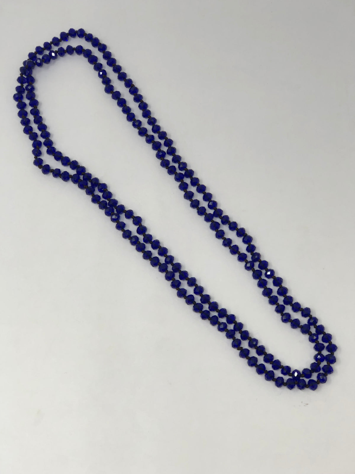 60-inch dark brown crystal beaded necklace with knotting between beads and no clasp