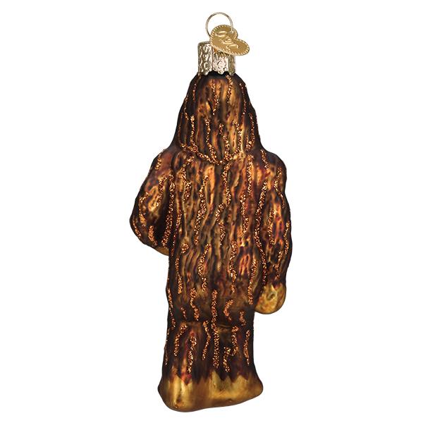 Back view of a brown glittery glass Sasquatch Christmas ornament with a gold heart charm.